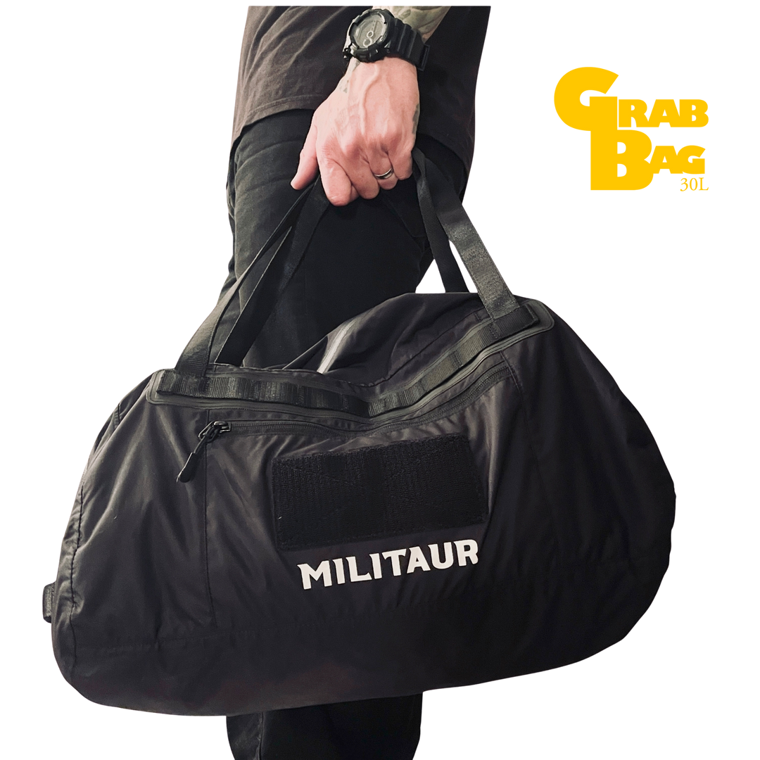 Militaur 30 Liter grab bag go bag in black being held and carried